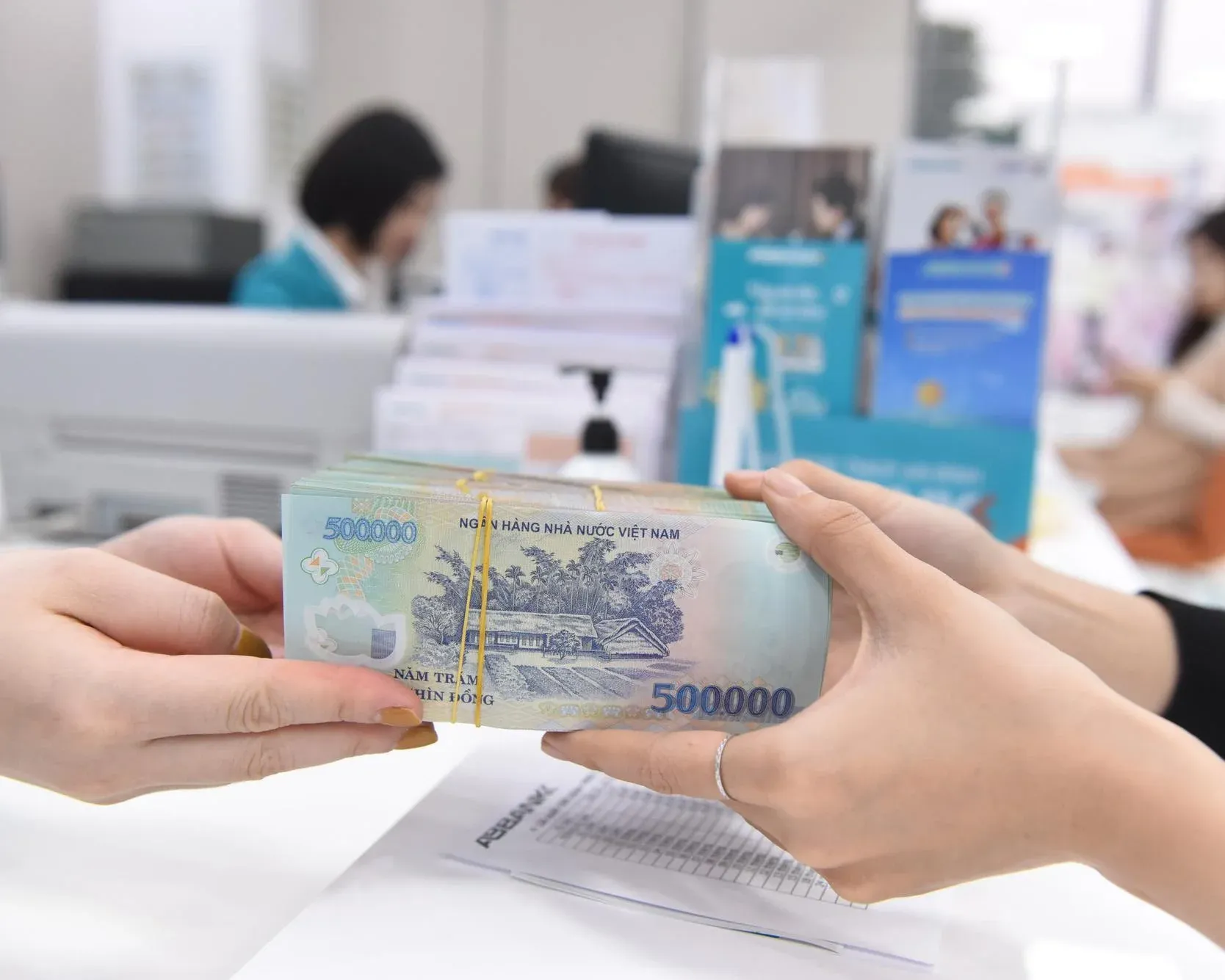 Cash exchange at a Vietnamese bank counter