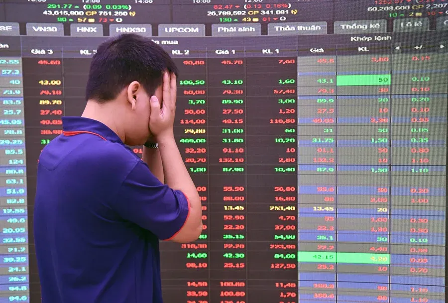 Retail investor anxiously watching falling stock prices on trading board