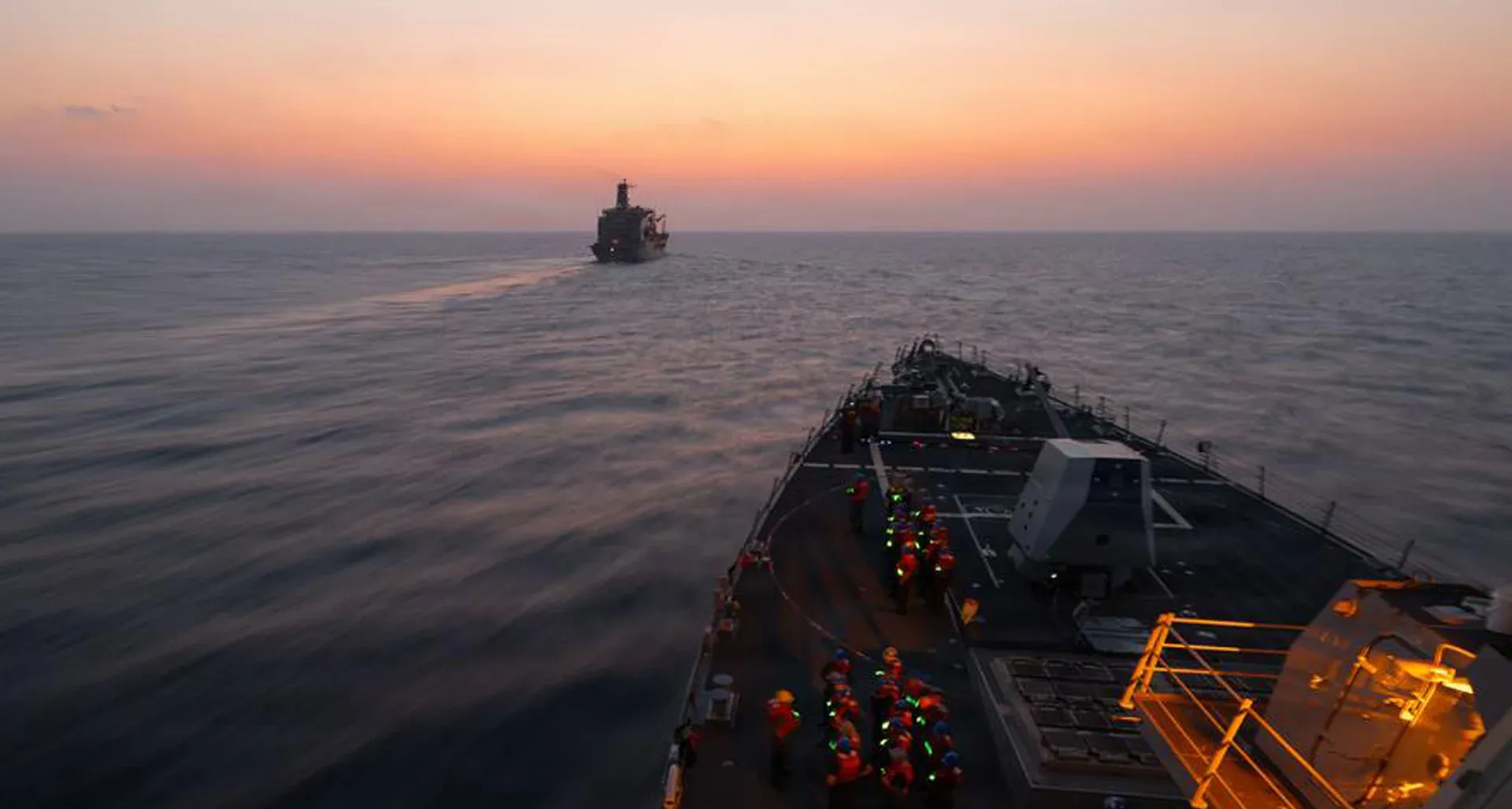 U.S. Navy destroyer on patrol in the Persian Gulf at dusk
