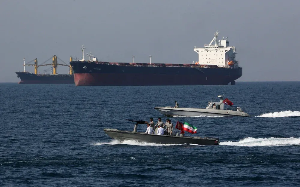 Iranian military boats patrolling near an oil tanker in the Strait of Hormuz
