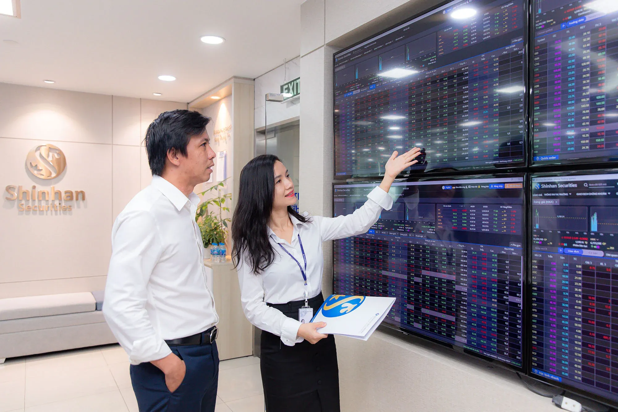 Investors monitoring the stock ticker board at a securities firm in Vietnam