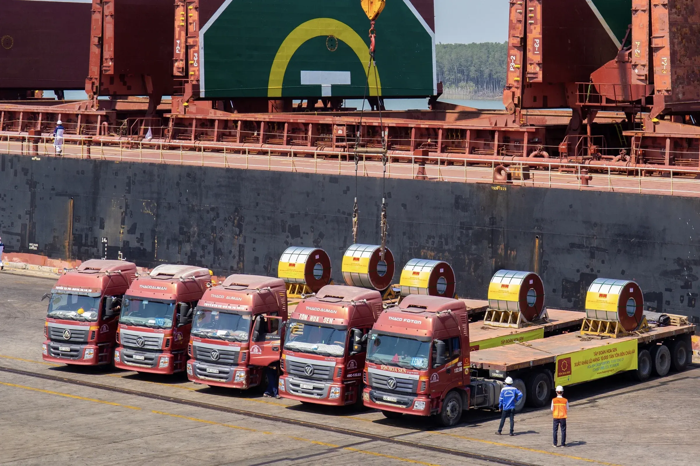 Steel coil trucks lined up at a Vietnamese port for export
